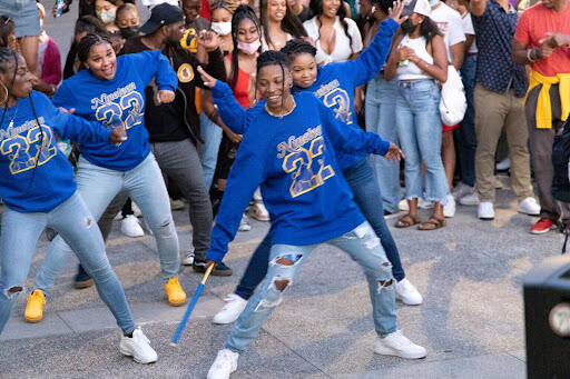 students wearing matching blue shirts dancing 